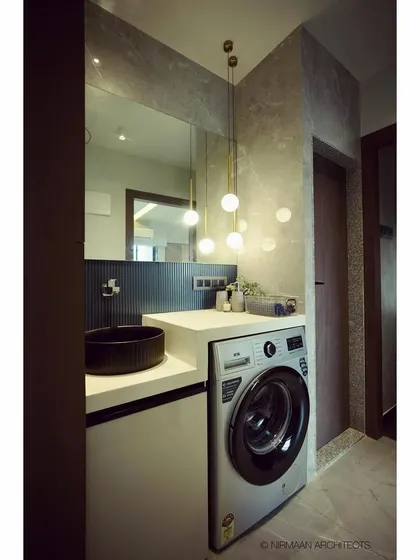 In this passage, we rearranged walls to create a compact utility area with a washing machine and a stylish washbasin, proving that even functional spaces can be beautifully designed.