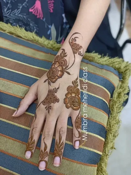 A single floral vine on the back of the hand, perfect for a simple yet elegant look.