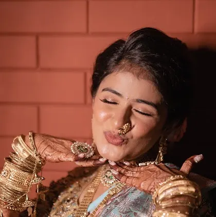 A playful moment with the bride. Her makeup is flawless and radiant, making her look like a movie star.