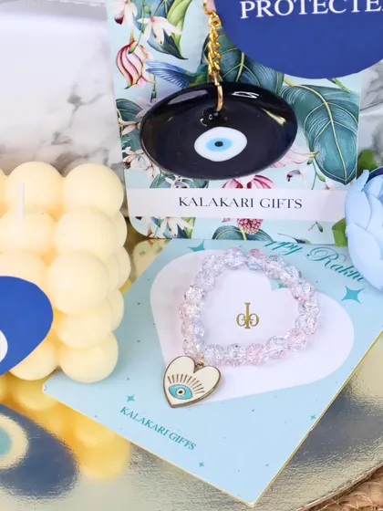 A close-up of the Evil Eye Rakhi hamper, showing the beautiful evil eye bracelet and keychain, designed to offer protection and good vibes.