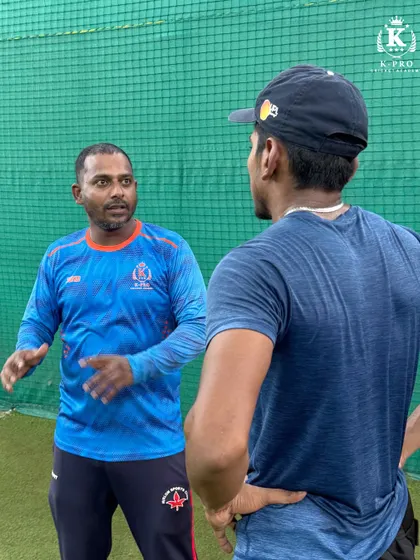 A coach engaged in a one-on-one discussion with a player, providing personalized feedback and strategy. This is the core of our coaching philosophy.