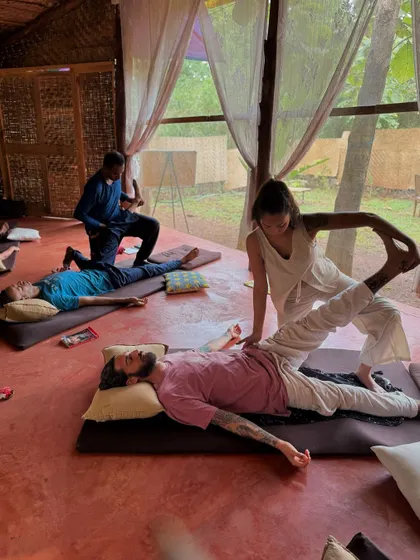 A full-body view of an assisted stretch. This dynamic movement helps to mobilize the spine and open the entire front side of the body.