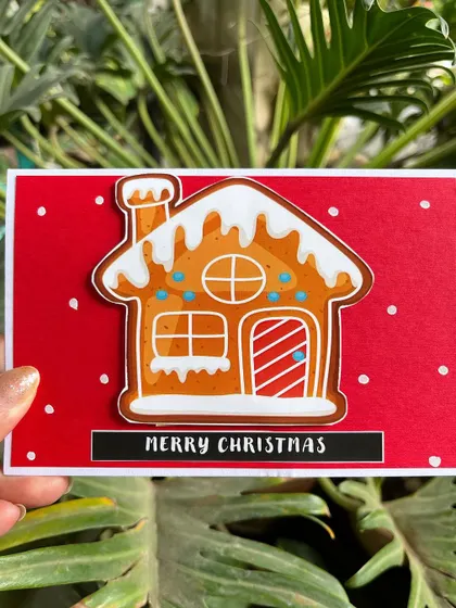 This image highlights the charming details of our gingerbread house Christmas card, from the candy cane door to the snowy roof.