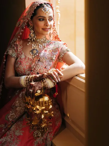 The bride by the window, with the natural light beautifully illuminating her and her custom-made kaliras.