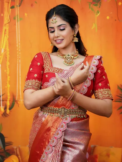 A radiant bride in a classic red silk saree. The rich color and gold embroidery are perfect for wedding ceremonies, creating a timeless and photogenic look.
