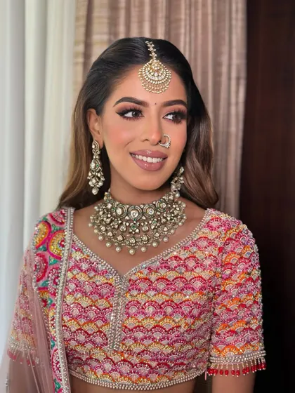 A happy bride is the most beautiful bride. Anjali is glowing with her sharp liner and warm, shimmery eyeshadow.