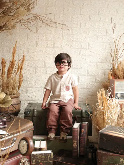 A classic portrait from the vintage-themed session. The young boy sits poised and calm, looking like a character from a classic storybook.
