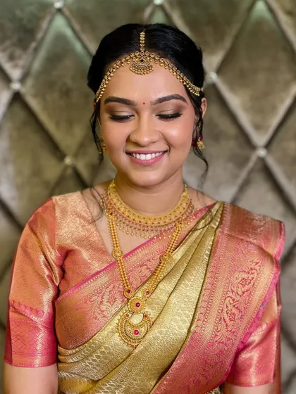 A beautiful 2-states bride, ready for her South Indian ceremony. The makeup is soft and glowing, paired with traditional gold jewelry.