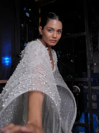 A backstage shot from the Gaurav Gupta show, capturing the 'glass skin' makeup look. The goal was to create a luminous, almost wet-looking complexion.