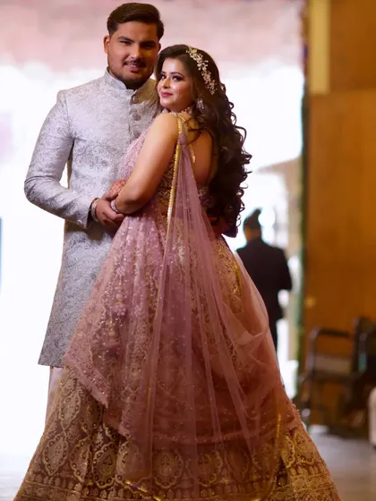 The happy couple posing together. Her lavender lehenga and his coordinated sherwani make for a perfect pair.