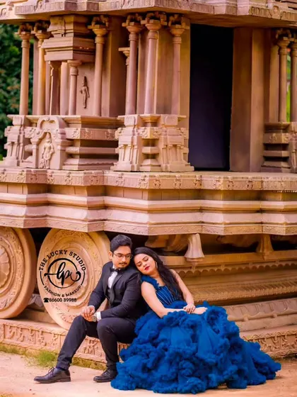A quiet, romantic pose from a pre-wedding shoot at a temple-themed location. I provided the royal blue ruffled gown and the groom's classic black suit, with makeup designed for an elegant evening look.
