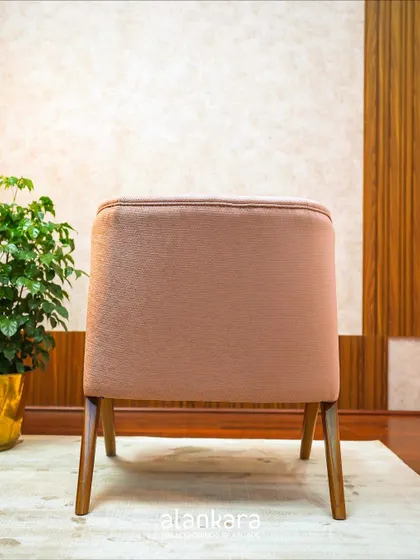 The back of my Y-Chair design, showcasing the clean lines of the teak wood frame and the smooth finish of the light pink upholstery.