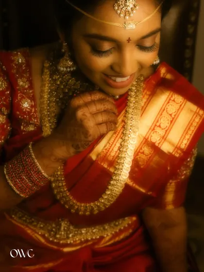 A close-up of the bride admiring her beautiful gold jewellery.