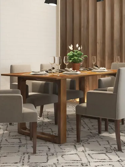 A simple and modern dining setup with comfortable upholstered chairs. The wooden table and slatted wall panel add warmth to the space.