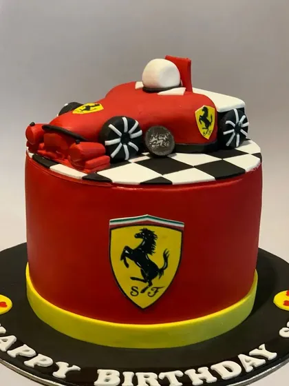 For the racing fan, a custom Ferrari-themed birthday cake. This cake features the iconic red car, checkered flag details, and the Ferrari logo, perfect for a high-speed celebration.