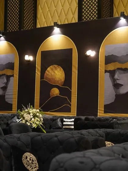 The 'Black Luxe' theme in full swing. We used abstract art panels, plush black velvet seating, and focused spotlights to create a modern and sophisticated lounge area for the Sangeet night.
