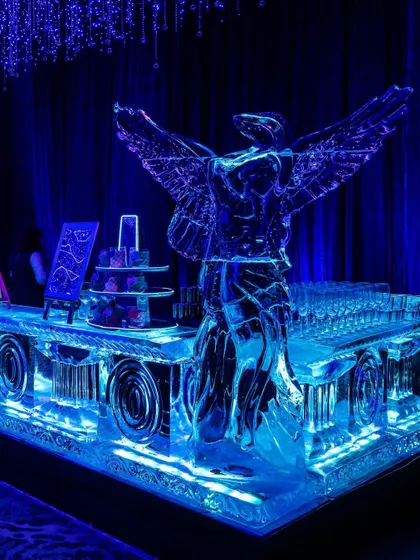 This custom-sculpted ice bar, featuring an angelic figure, was a functional work of art. Illuminated with deep blue light, it served as a spectacular centerpiece for the cocktail hour, blending artistry with hospitality.