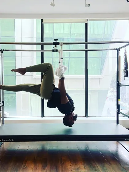 The single-leg tabletop pose on the Cadillac is a powerful exercise for building core stability and unilateral strength.