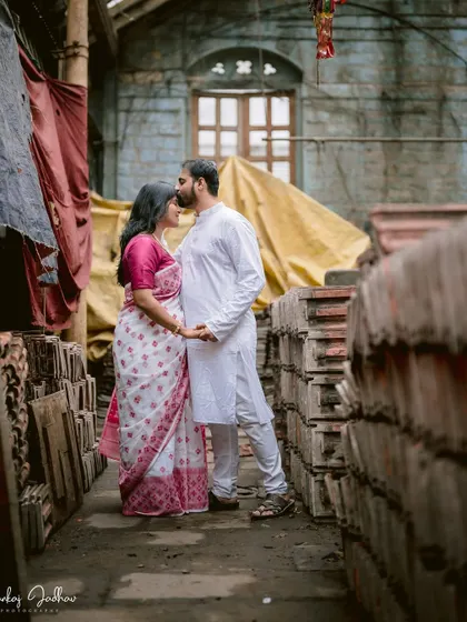 A tender forehead kiss in a rustic setting. The textures of the old building and the soft light add to the romantic, cinematic feel of this pre-wedding portrait.