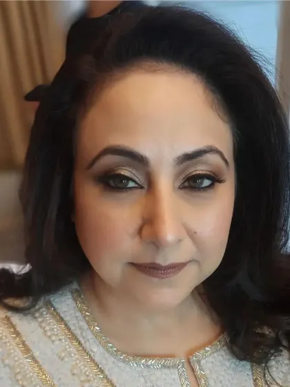 A classic party makeup look with a soft brown smokey eye and a neutral matte lip. This timeless style is suitable for a wide range of events and outfits.