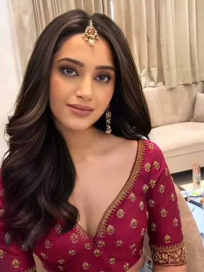 We are in love with these romantic curls. This soft, open hairstyle with a simple maang tikka is perfect for a pre-wedding pooja or a family gathering.