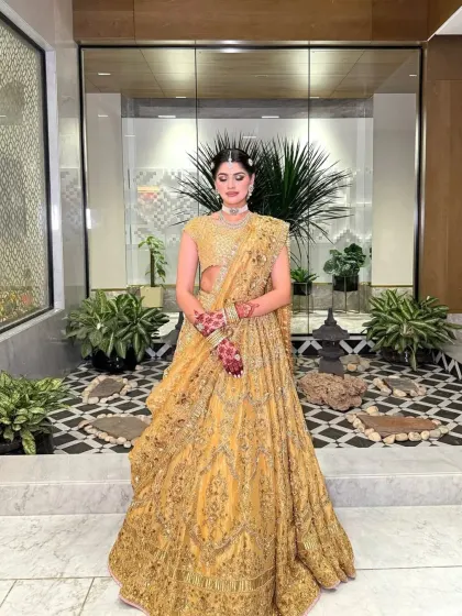 The full view of this stunning golden lehenga, showcasing its beautiful flare and intricate workmanship. A true statement piece for any bride.