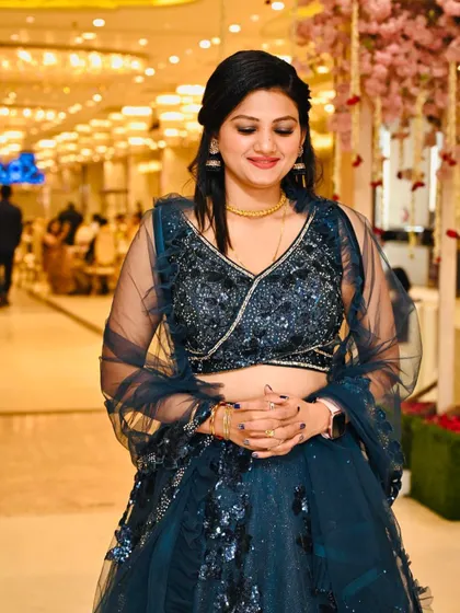 A candid shot of a client at an event. Her makeup looks natural and beautiful, even in the ambient lighting of a banquet hall.