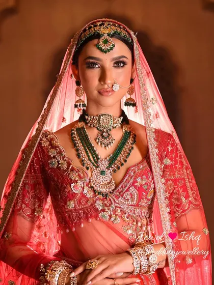A direct, confident portrait of the bride showcasing her full jewellery set. The combination of the choker, long necklace, and headpiece creates a powerful and regal statement.