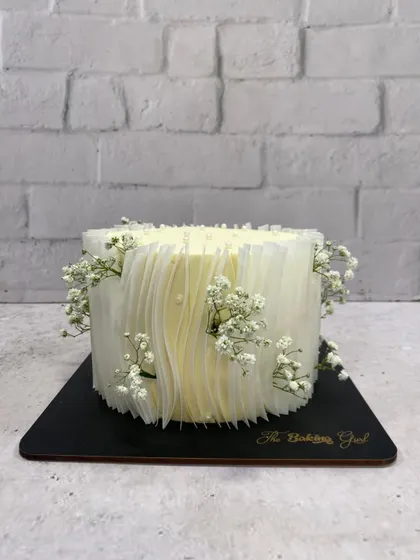 The clean lines and delicate floral touches make this cake a truly sophisticated choice.