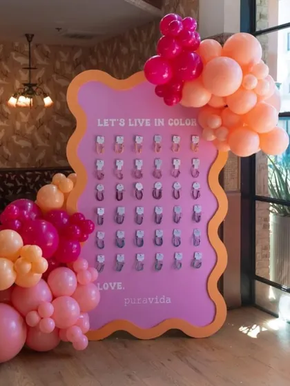An interactive brand activation setup for a PR event. This custom board invites guests to 'Live in Color' and take a branded keychain.