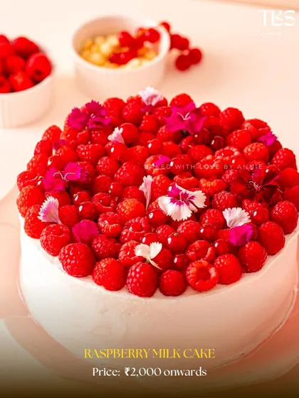My Raspberry Milk Cake is a true beauty. It's topped with a mountain of fresh raspberries and delicate edible flowers, making it a stunning centerpiece.