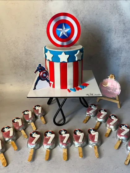 This Captain America themed cake was part of a set for a 7th birthday party. The cake features the iconic shield and stripes, and I also made matching cakesicles for all the guests.