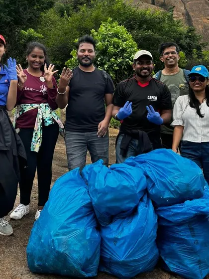 A small group proudly stands with the trash they collected. Every bit counts, and these drives instill a strong sense of environmental responsibility.