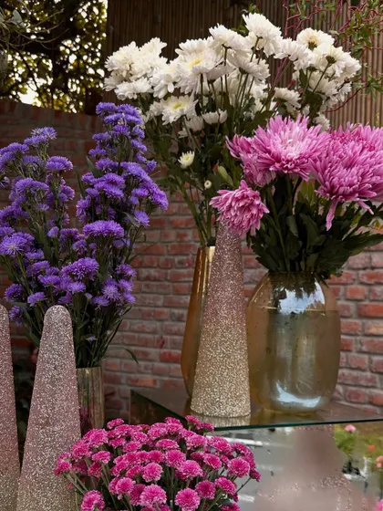 A close-up of the fresh purple, white, and pink chrysanthemums used in our floral arrangements.