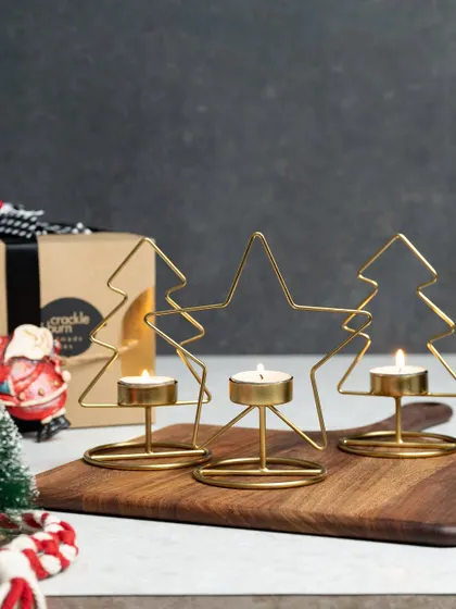 These wireframe tea light holders are a modern and minimalist way to decorate for the holidays. This set includes two Christmas trees and a star, all in a beautiful gold finish.