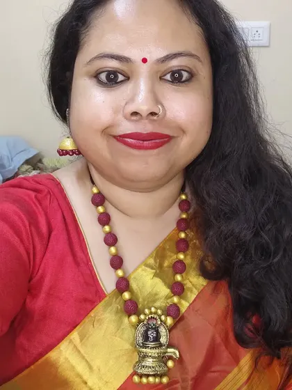 A selfie of me wearing the Shivalingam necklace. It's a piece I designed for Mahashivratri, combining a sculpted pendant with rudraksha-style terracotta beads for a truly devotional feel.