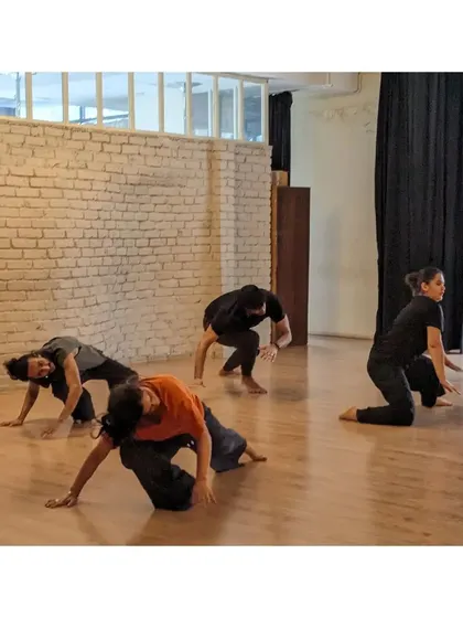 Dancers explore animalistic floor movements, a creative exercise to build strength and body awareness.