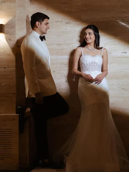 A chic and modern look for a cocktail party or reception. The bride's hair is styled in soft waves, complementing her elegant white gown.