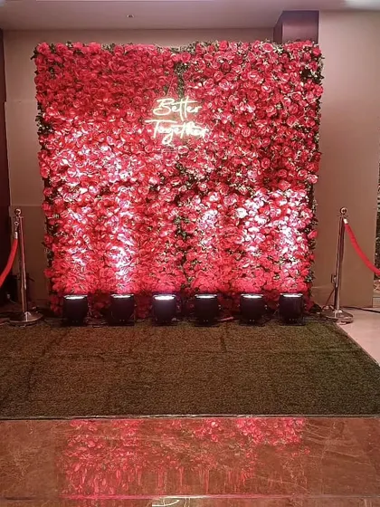 A full wall of red roses with a "Better Together" neon sign. This creates a very dramatic and romantic photo backdrop, perfect for making a statement at your event.
