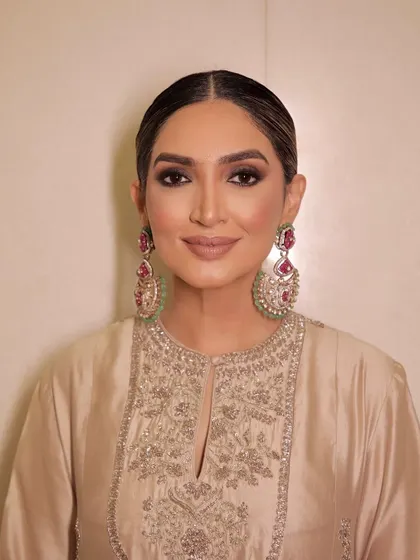 A portrait focusing on the sharp, smokey eye makeup and the flawless base.