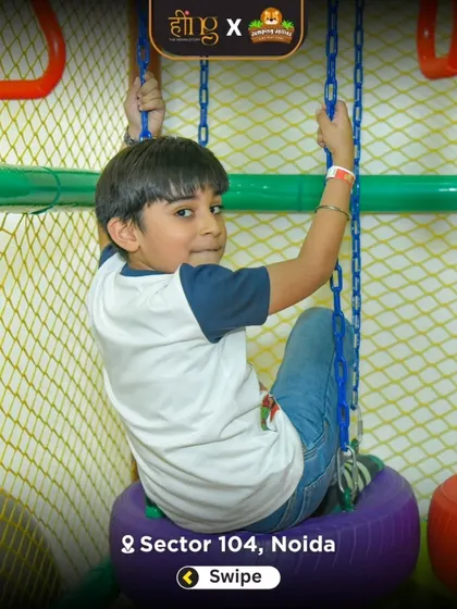 A boy tests his strength and coordination on the tire swing, part of our indoor ninja course. This area is designed for older kids looking for a bit more of a challenge.