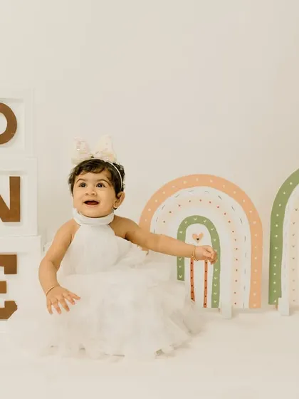 Another beautiful shot from the boho rainbow first birthday session. This little princess is all smiles in her lovely white dress.