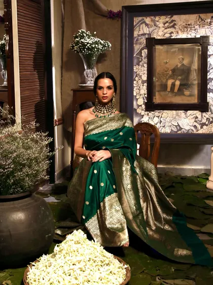 A wide shot that captures the opulence of the entire scene for the Soho Begum campaign, from the model's attire to the floral decor.