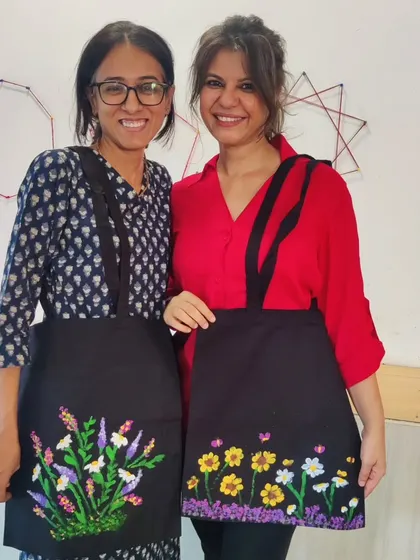 Two teachers from the Inodai Waldorf School showing the floral aprons they painted. Art is for everyone, and it's always inspiring to see educators embrace their own creativity alongside their students.