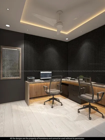 A home office designed for focus and productivity. The room features sound-dampening wall panels, a large L-shaped wooden desk, and a false ceiling with cove lighting.