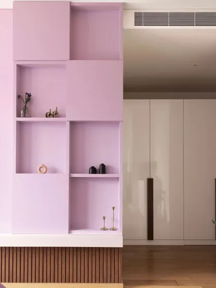 In the purple-themed bedroom, I designed this geometric open-and-closed shelving unit. It provides space for display and storage while adding a modern, sculptural element to the room.
