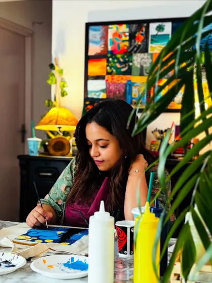Sanchita, completely in the zone, painting her Starry Night tote bag. It's wonderful to see someone so focused and enjoying the creative process.