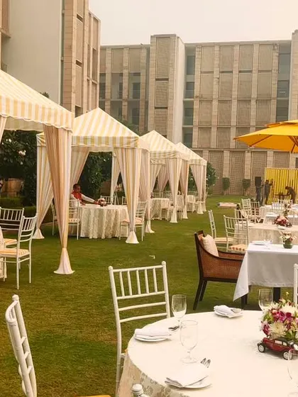 Another view of the brunch setup, focusing on the crisp white table linens and classic Chiavari chairs. The striped cabanas in the background add a touch of resort-style luxury.