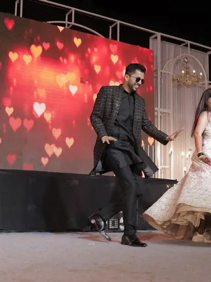 Another dynamic shot from the couple's dance performance. The joy and energy are palpable in this photograph.