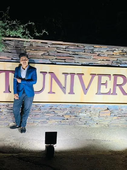 Posing by the NIIT University sign. Performing for students is a unique experience that requires a blend of entertainment and relatability. It's about showing them that the impossible is possible.
